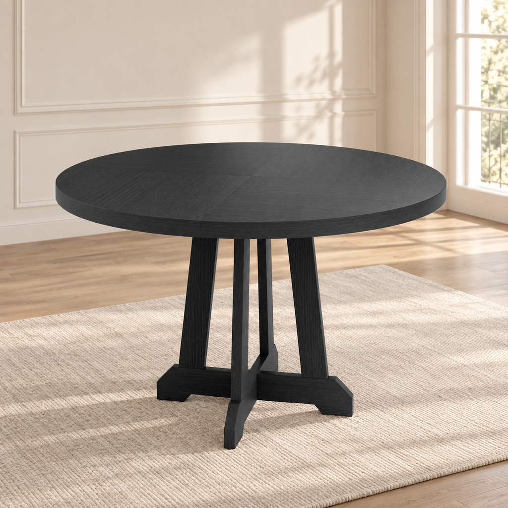 Table à manger ronde Noria 120 cm — plateau noir et pied central en X — produit seul dans un intérieur de maison